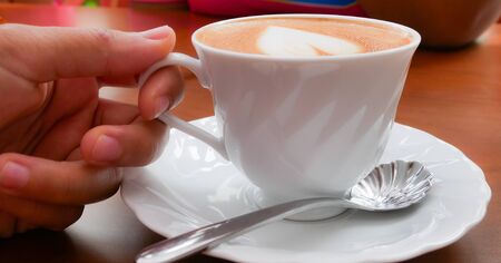 Close up Coffee heart shape in white cup.