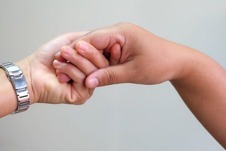 Close up hand couple on gray background.Love and Valentine's day concept.の写真素材