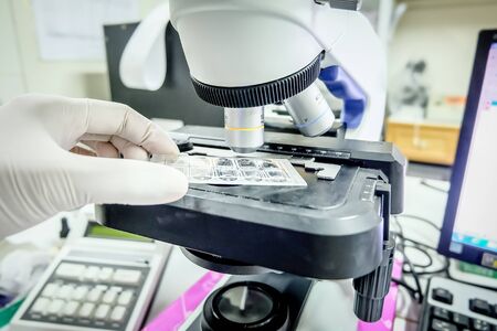 Microscope in laboratory for investigetion testing.White tone.
