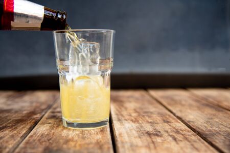 Beer in glass on wooden table drinking concept.