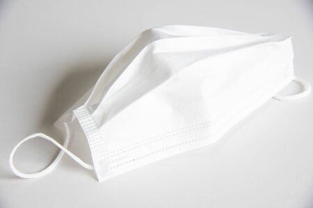 Close up white surgical mask on white background.