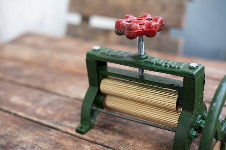 Green Squid grinding machine on wood table.