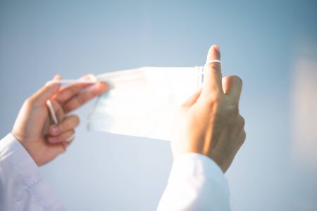 Blurred hand scientist with surgical mask protected corona virus or covid-19.