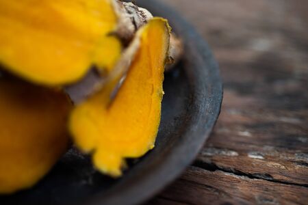 Fresh turmeric on wood table Thai herb concept.の写真素材