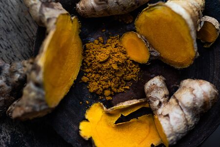 Fresh turmeric on wood table Thai herb concept.