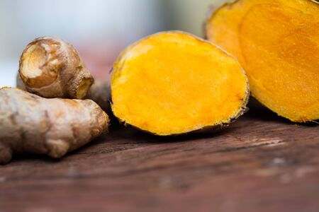 Fresh turmeric on wood table Thai herb concept.の写真素材