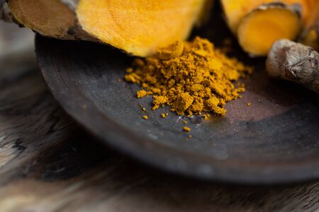 Fresh turmeric on wood table Thai herb concept.