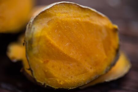 Close up yellow turmeric herb on wood table.の写真素材