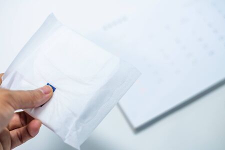 White sanitary napkin with calendar on whitebackground.