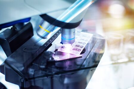 Close up objective lens microscope in laboratory.