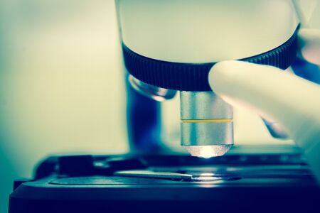 Close up objective lens microscope in laboratory.