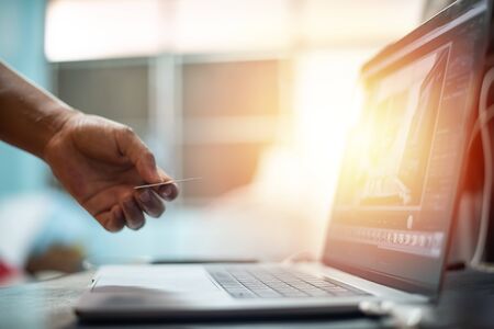 Hand with credit card with laptop in shopping online concept.の写真素材