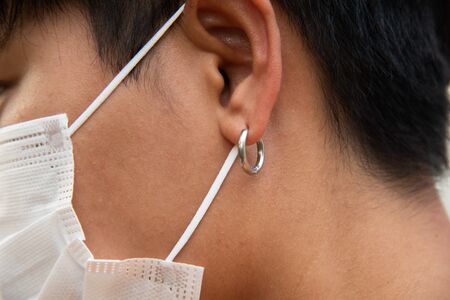 Asian people using surgical mask protecting coronavirus or COVID-19 virus.