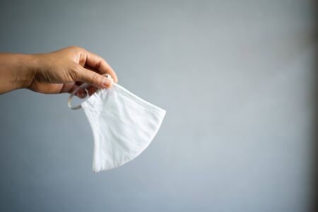 People with surgical mask on grey background with protected corona or COVID-19 virus.