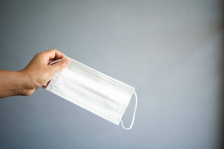 People with surgical mask on grey background with protected corona or COVID-19 virus.の写真素材