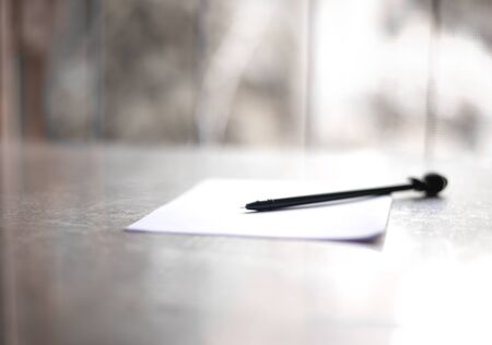Paper with pen on wood table in writing letter concept.の写真素材