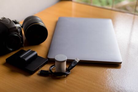 Laptop with lens on table in work space concept.