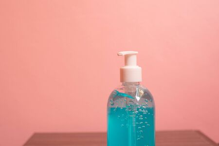 Close up blue alcohol gel on pink pastel background.の写真素材