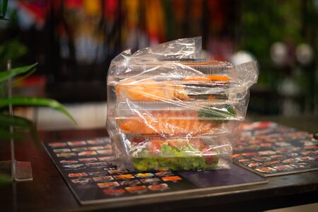 Food deliver sushi in box effect of corona virus.の写真素材