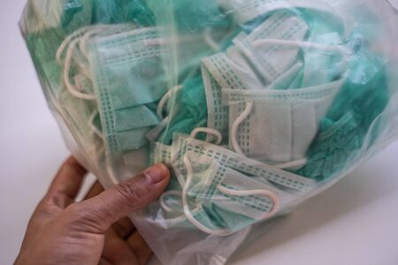 Packing trash surgical mask in plastic bag to prevent corona or Covid-19 virus.