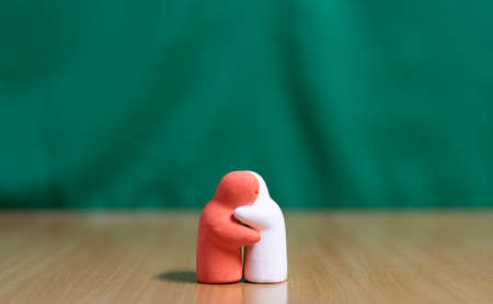 People Huging in love concept on green background.