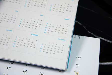 Blurred calendar in planning concept on black  background.