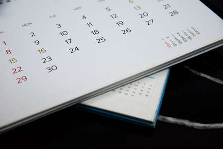 Blurred calendar in planning concept on black  background.の写真素材