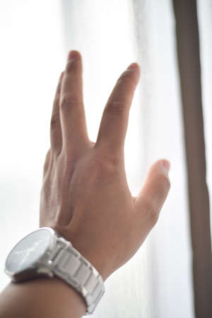 Hand touch on smooth white fabric.