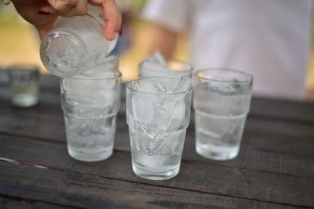 Group Glass of ice on wood table.