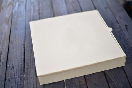 Brown box on wood texture in delivery concept.