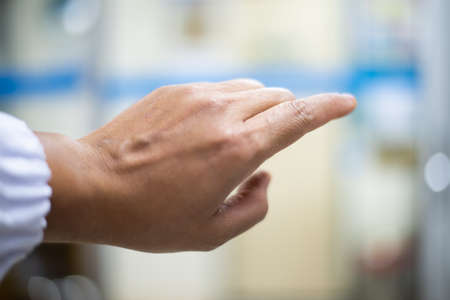 Hand scientis with out glove on blur background.の写真素材