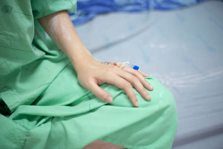 Close up hand of patient Covid-19 on heparin lock in hospital.の写真素材