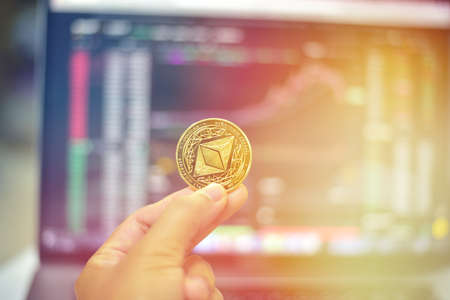 ethereum coin on blur cryptocurrency market background.Business and digital financial cocept.