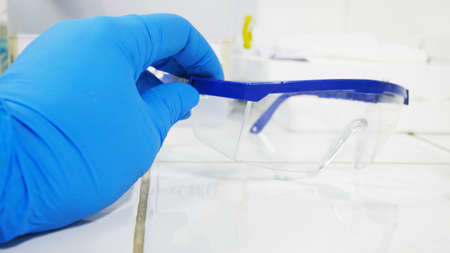 Hand scientis testing in glove laboratory concept.