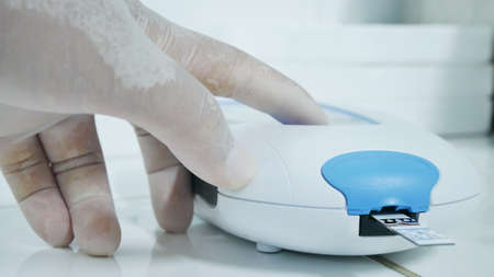 Hand scientis testing in glove laboratory concept.の写真素材