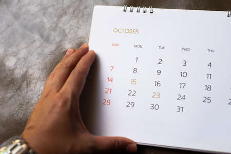 White calendar on brown leather background in planning concept.の写真素材