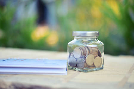 Coin on blur background in save money concept.