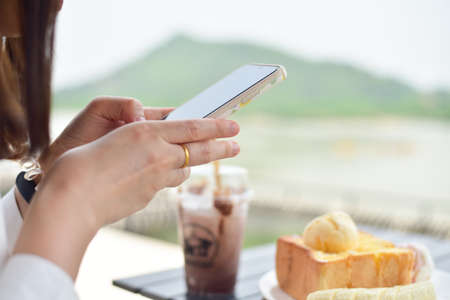 Honey toast with banana on white plate in coffee shop.の写真素材