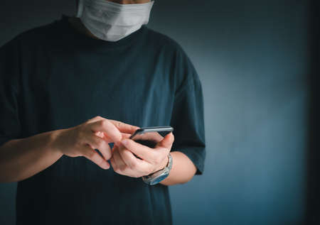 Business man using smartphone on blur background technology communication concept.の写真素材