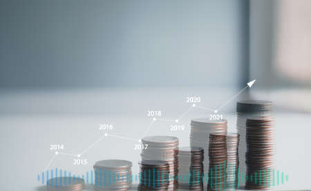 stacking coins with a graph of profit. Business successful growing.