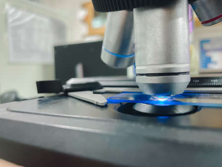 Close up objective lens of microscope in laboratory.