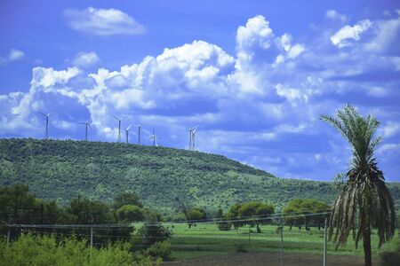 Wind farm turbine fan renewable energy electric generation equipment in the mountains of India