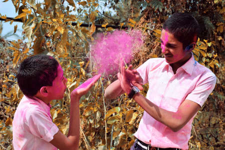 Two boys are playing in colors in happy posture, Concept for Indian festival Holi