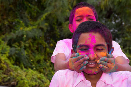Two boys are playing in colors in happy posture, Concept for Indian festival Holiの写真素材