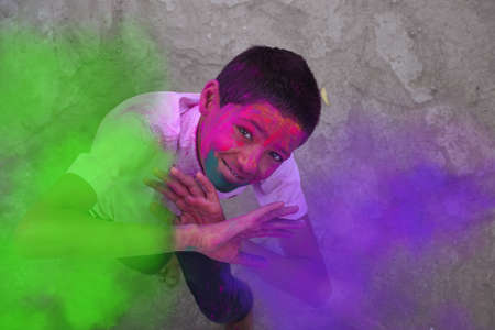 Little boy playing with colors, In a happy mood, Concept for Indian festival Holiの写真素材