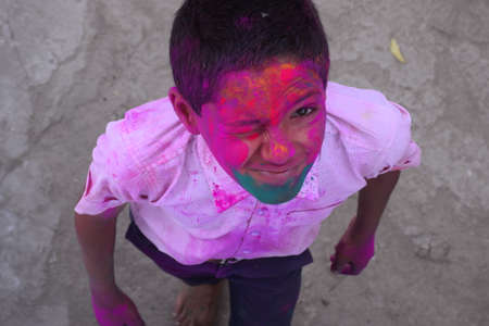 Boy playing with colors, In a happy mood. Concept for Indian festival Holiの写真素材