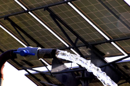 agricultural equipment for field irrigation, water jet, behind which is solar panel's,
