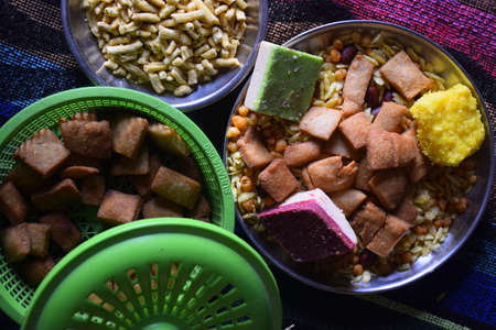 Indian breakfast milk sweets and snacks colorful cloth in the background