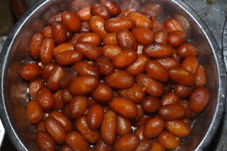 India's famous sweets Gulab Jamuns are adorned with steel plates.