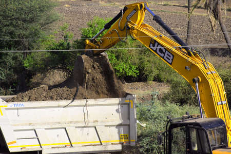 The modern excavator JCB performs excavation work on the construction site